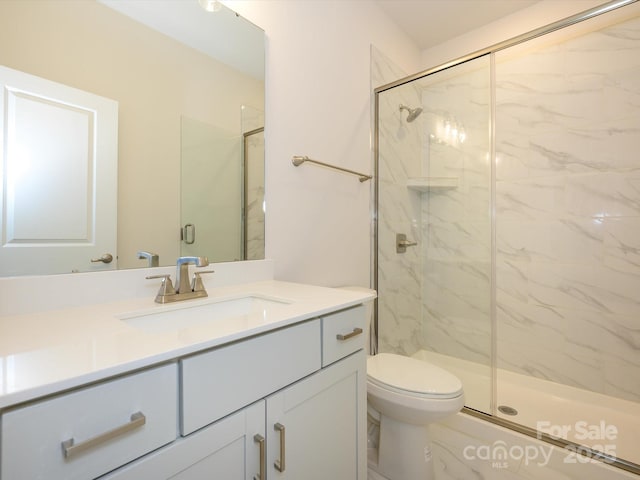 full bathroom with vanity, toilet, and a marble finish shower