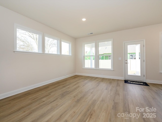 interior space featuring recessed lighting, baseboards, visible vents, and light wood finished floors