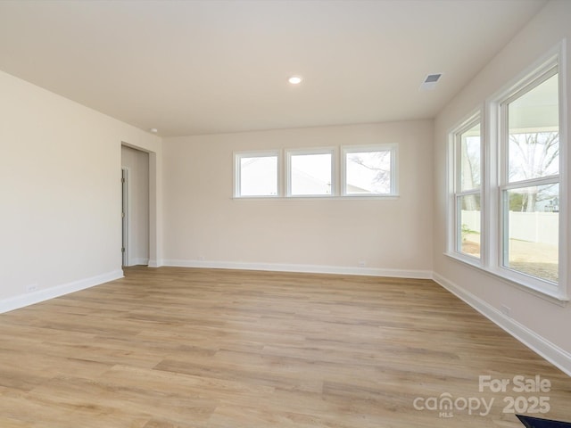 spare room featuring visible vents, recessed lighting, baseboards, and light wood-style floors