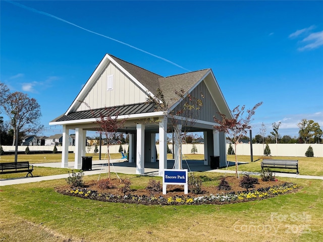 view of property's community with a gazebo, a lawn, and fence