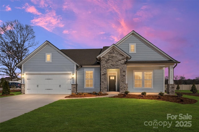 view of front of home featuring concrete driveway, a front yard, and stone siding