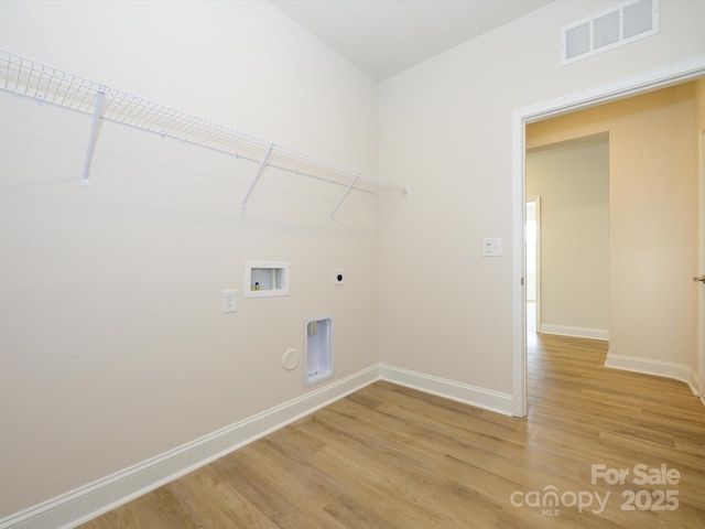 laundry area with baseboards, visible vents, laundry area, hookup for a washing machine, and light wood finished floors