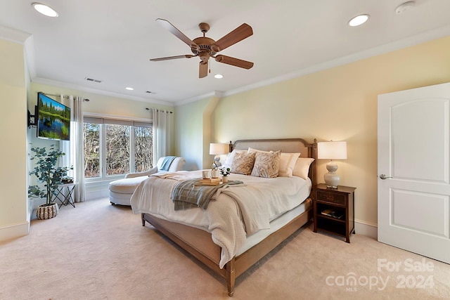 bedroom with ornamental molding, ceiling fan, and light carpet