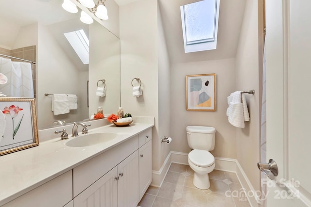 bathroom with lofted ceiling with skylight, vanity, toilet, and tile patterned floors