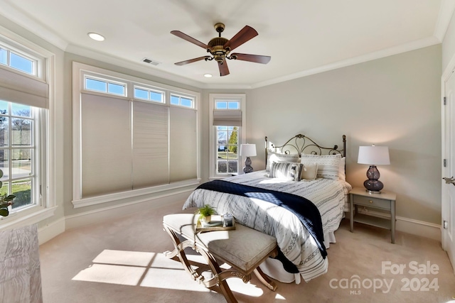 carpeted bedroom with ornamental molding and ceiling fan