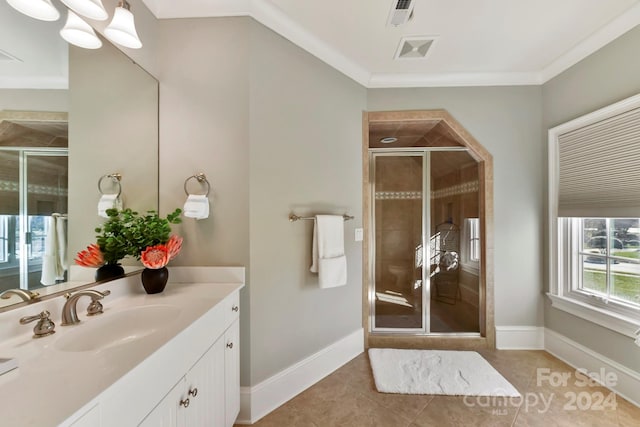 bathroom featuring ornamental molding, vanity, tile patterned floors, and an enclosed shower