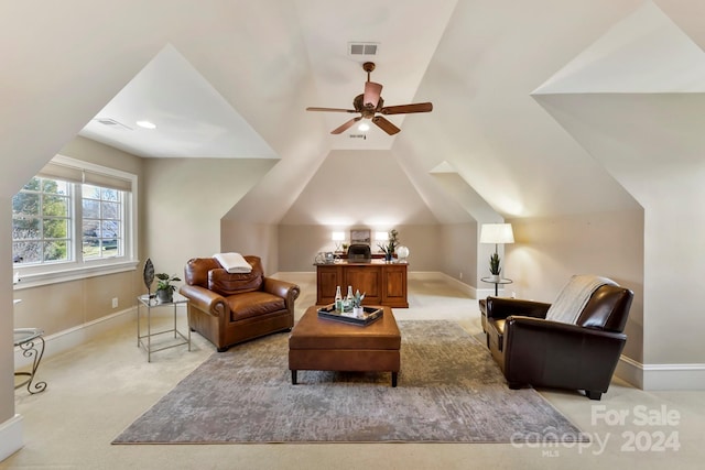 living area featuring vaulted ceiling, light carpet, and ceiling fan