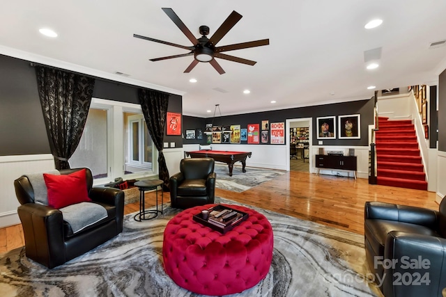 living room featuring wood-type flooring, pool table, ceiling fan, and crown molding