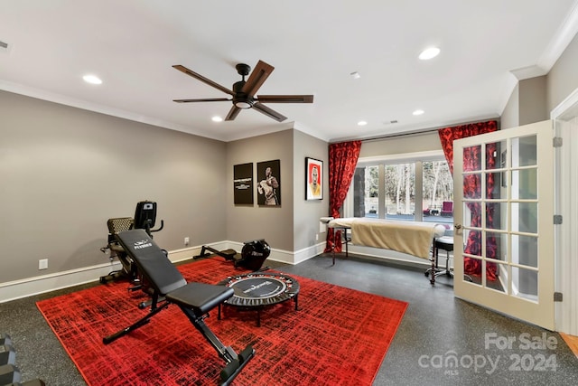 workout room featuring ceiling fan and ornamental molding