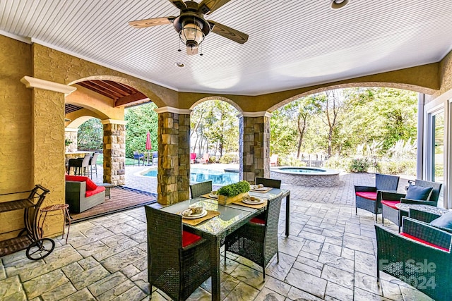 view of patio / terrace featuring an outdoor living space, ceiling fan, and a pool with hot tub