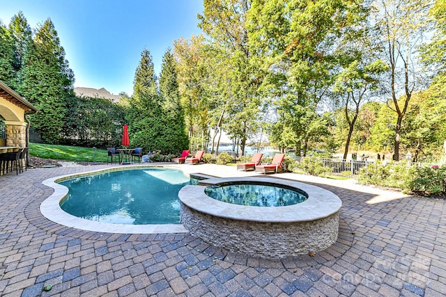 view of swimming pool with a patio and an in ground hot tub