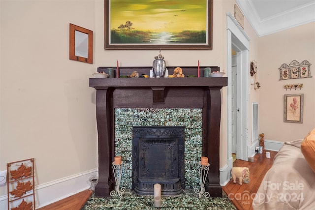 room details featuring crown molding, a fireplace, and hardwood / wood-style floors