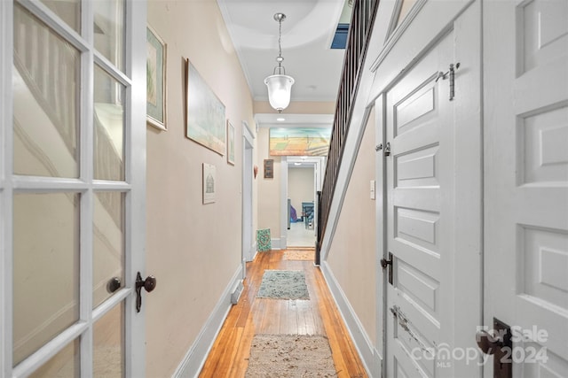 hallway with hardwood / wood-style flooring