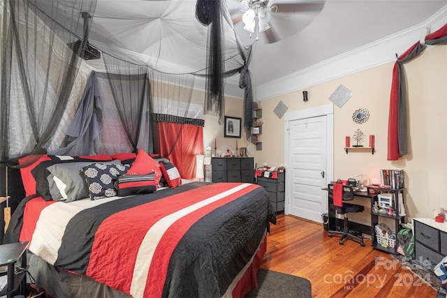 bedroom with wood-type flooring, ceiling fan, and crown molding