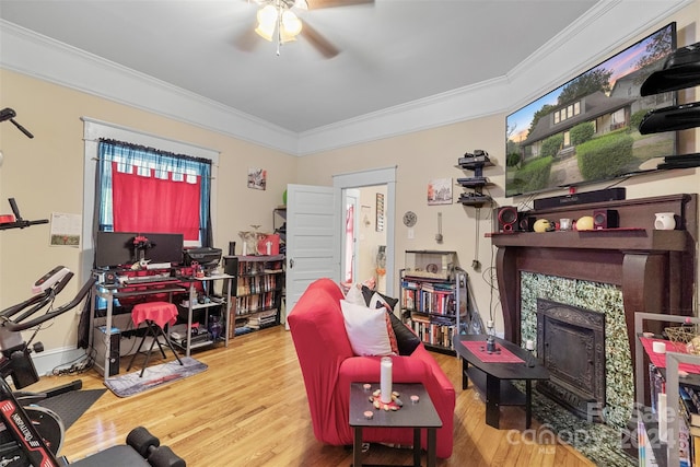 interior space with ornamental molding, wood-type flooring, and ceiling fan