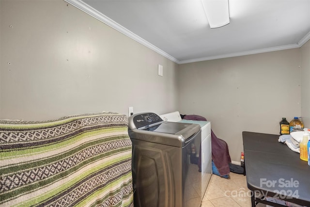 laundry room with ornamental molding and light tile patterned floors