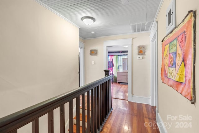 hallway featuring crown molding and dark hardwood / wood-style flooring