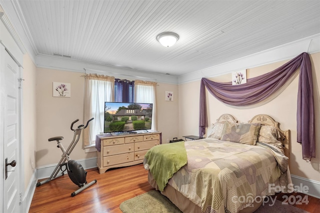 bedroom featuring light hardwood / wood-style floors and ornamental molding