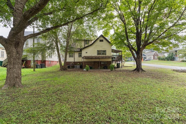 view of front of house with a front yard and a deck