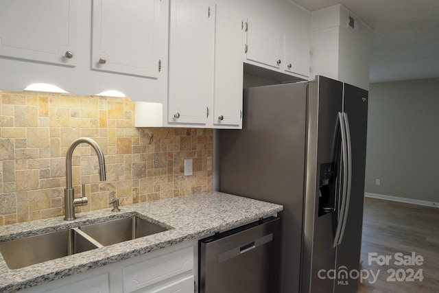 kitchen featuring sink, white cabinetry, appliances with stainless steel finishes, dark hardwood / wood-style floors, and light stone countertops