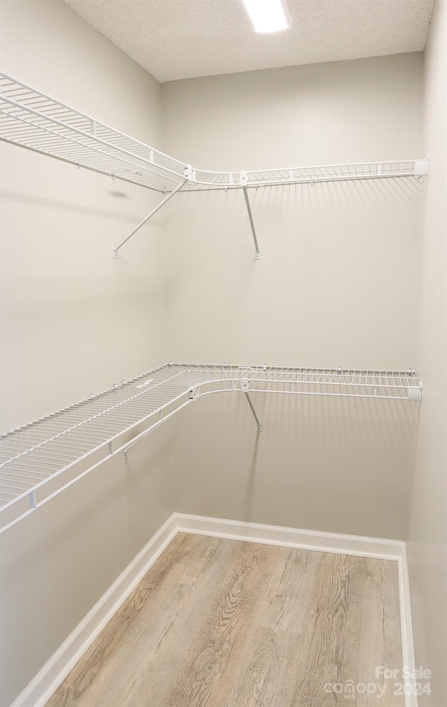 walk in closet featuring hardwood / wood-style flooring