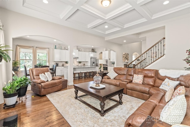 living room with light wood-type flooring, beamed ceiling, and coffered ceiling