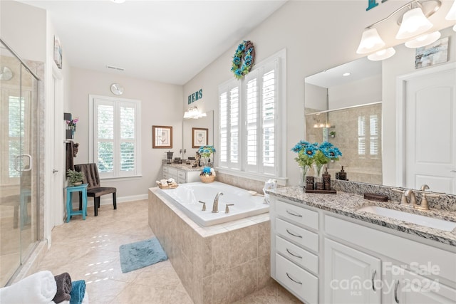 bathroom featuring plenty of natural light, separate shower and tub, and vanity