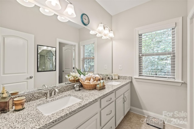 bathroom with plenty of natural light, tile patterned flooring, and vanity