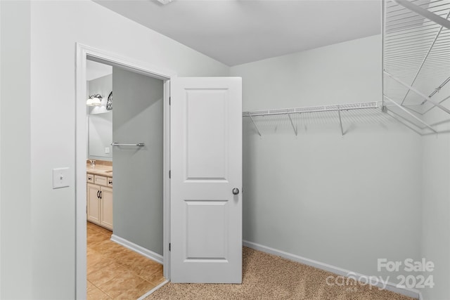 spacious closet with light tile patterned flooring