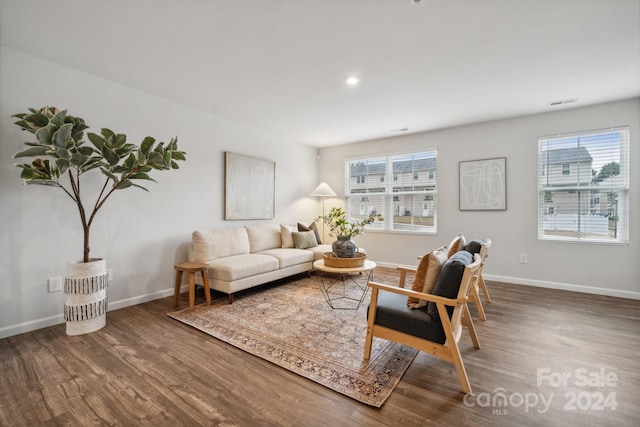 living room with a healthy amount of sunlight and hardwood / wood-style flooring