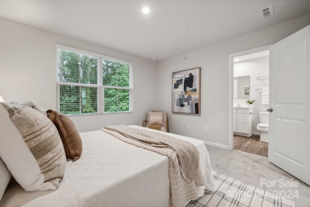 carpeted bedroom with connected bathroom