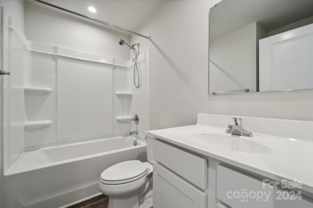 full bathroom featuring shower / washtub combination, wood-type flooring, vanity, and toilet