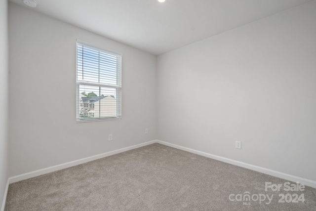 empty room featuring light carpet