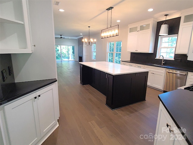 kitchen featuring a kitchen island, dishwasher, and a healthy amount of sunlight