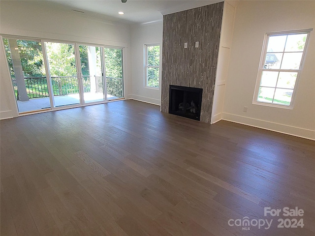 unfurnished living room featuring a fireplace and dark hardwood / wood-style floors