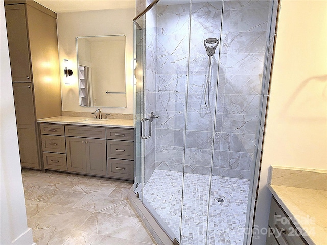 bathroom featuring vanity and a shower with door