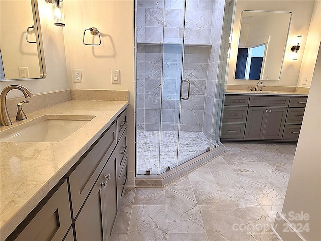 bathroom with a shower with door and vanity