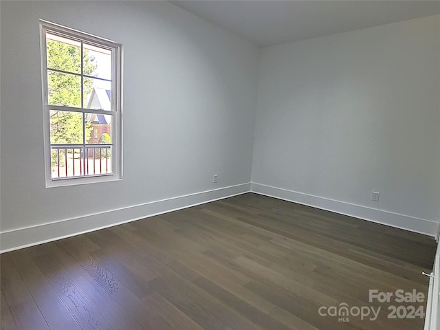 spare room with dark hardwood / wood-style flooring