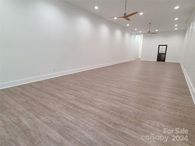 unfurnished room featuring dark hardwood / wood-style flooring, crown molding, and ceiling fan