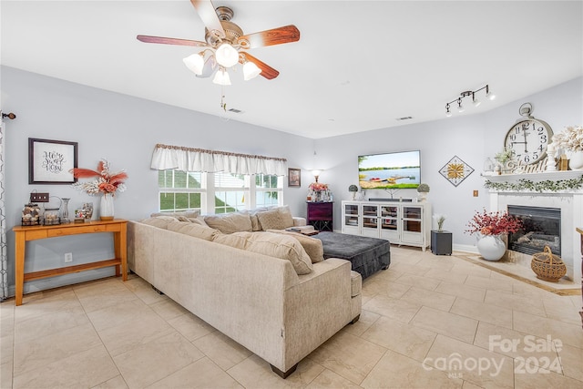 living room with ceiling fan and light tile patterned floors