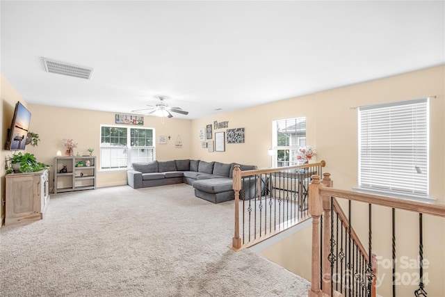 carpeted living room featuring ceiling fan