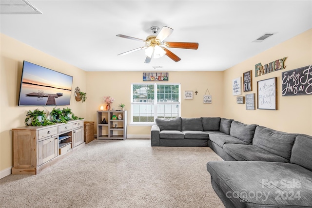 living room featuring ceiling fan and light colored carpet