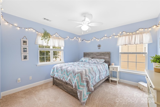 bedroom featuring ceiling fan and carpet