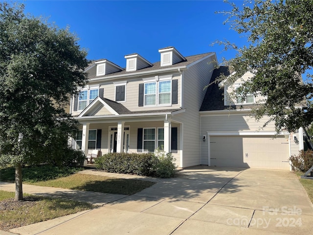 view of front of property featuring a garage and covered porch