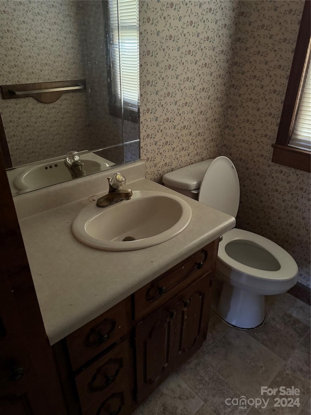 bathroom with vanity, tile patterned flooring, and toilet