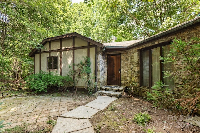 120 Pinewood Cir, Laurel Park, NC 28739 - view of front of property with a patio area, stucco siding, and stone siding