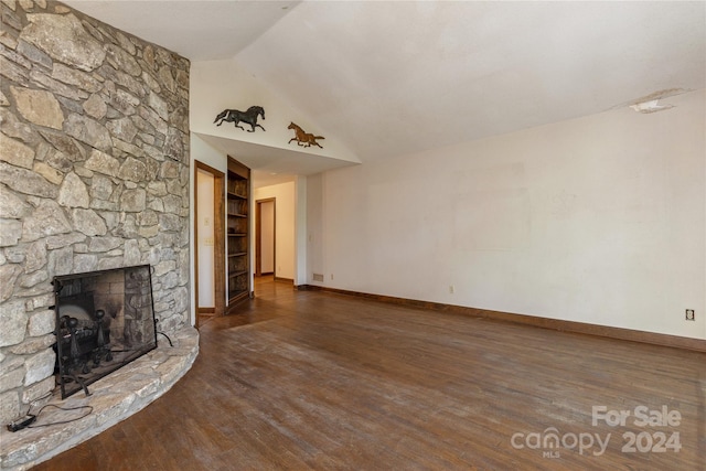 unfurnished living room with vaulted ceiling, a fireplace, and dark hardwood / wood-style floors