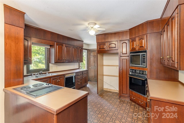 kitchen with black appliances, ceiling fan, kitchen peninsula, and sink