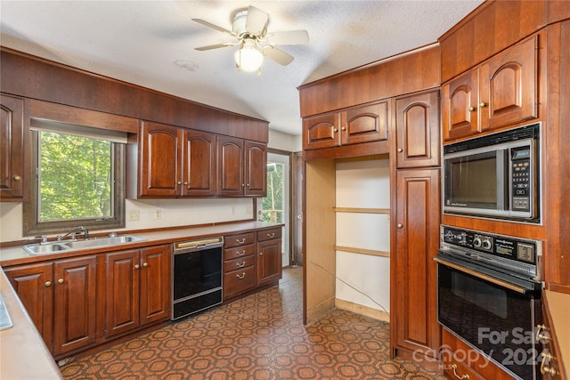 kitchen with plenty of natural light, black appliances, a textured ceiling, and sink