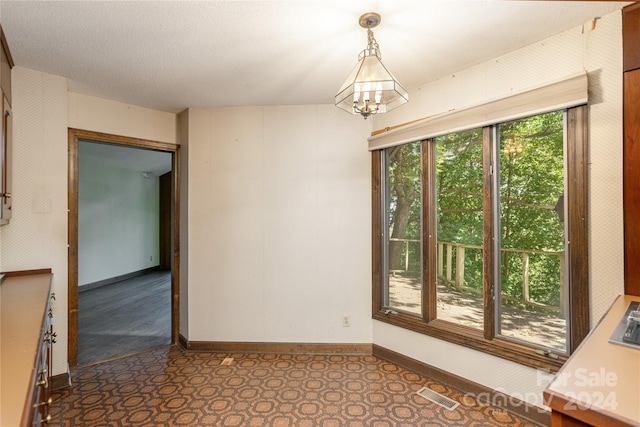 120 Pinewood Cir, Laurel Park, NC 28739 - unfurnished room with baseboards, visible vents, and an inviting chandelier